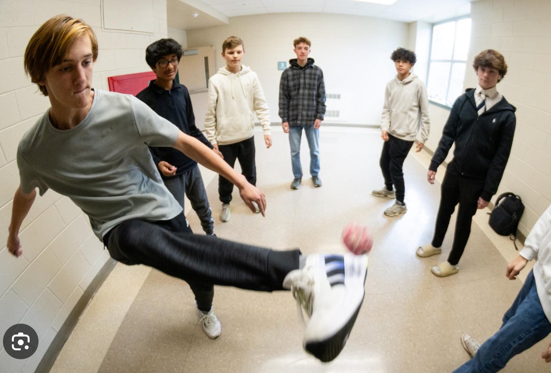 High school kids playing hacky sack